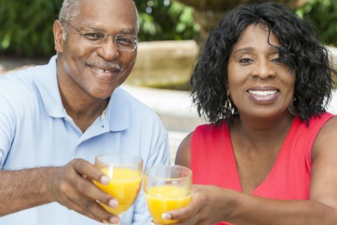 A couple toasting with orange juice. Having difficulty swallowing affects quality of life.